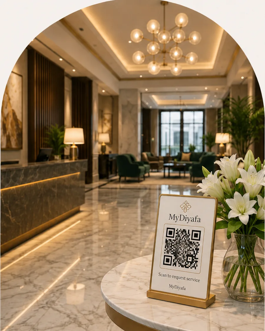 A MyDiyafa QR card on the reception table of a boutique hotel lobby